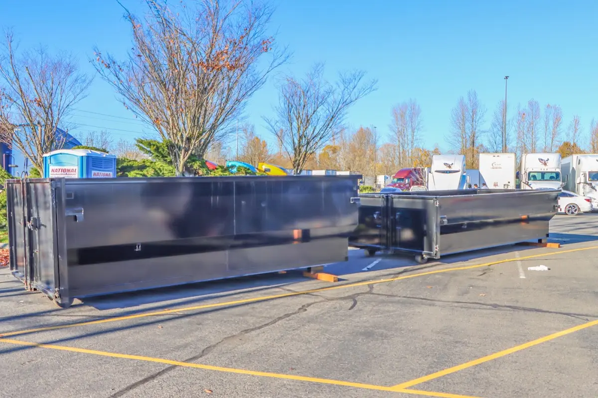 Professional dumpster rental service with roll-off container on residential driveway in New Baltimore